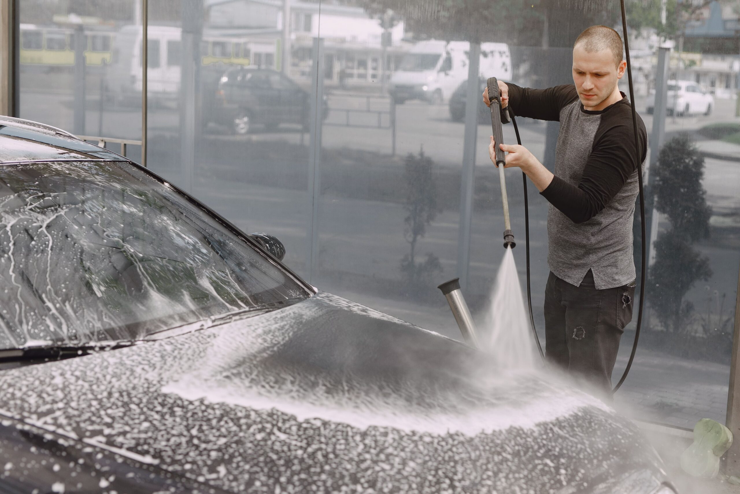 handsomen-man-black-sweater-washing-his-car