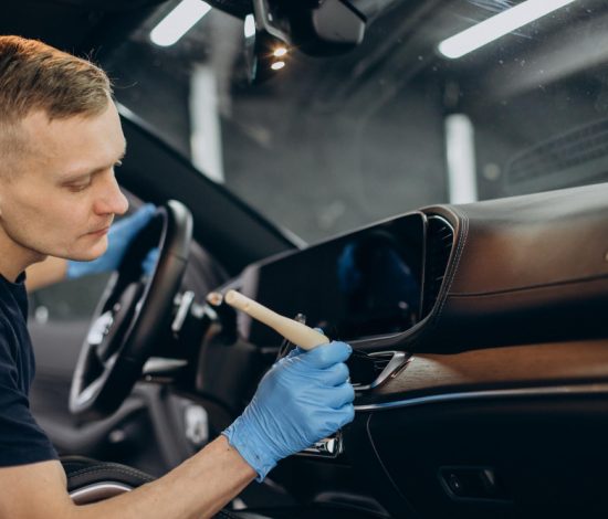 man-car-clean-using-brush-clean-up-all-details-inside-vehicle.jpg